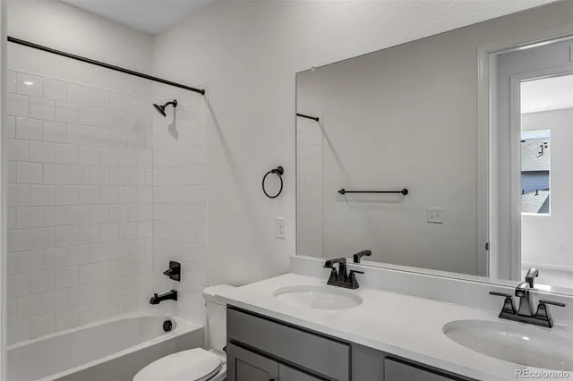a bathroom with a sink toilet tub and shower