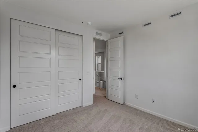 an empty room with closet area