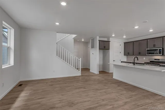 a view of kitchen with stainless steel appliances refrigerator microwave and stove
