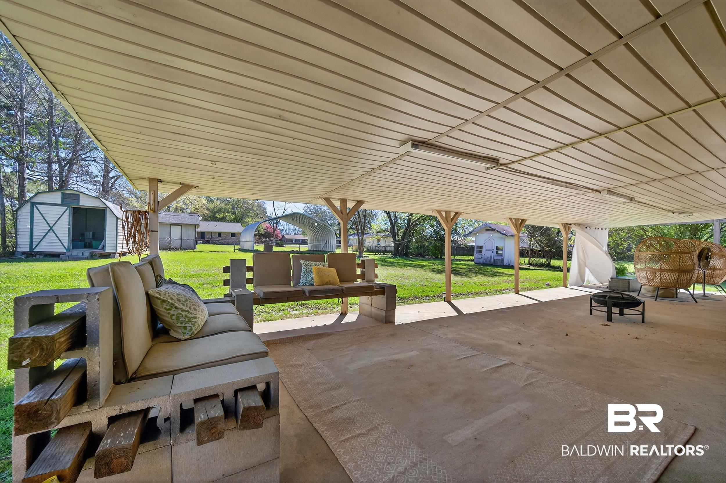 46006 Pecan Lane Bay Minette, AL 36507 - Photo 28 of 40 View of patio featuring a storage unit and an outdoor living space with a fire pit