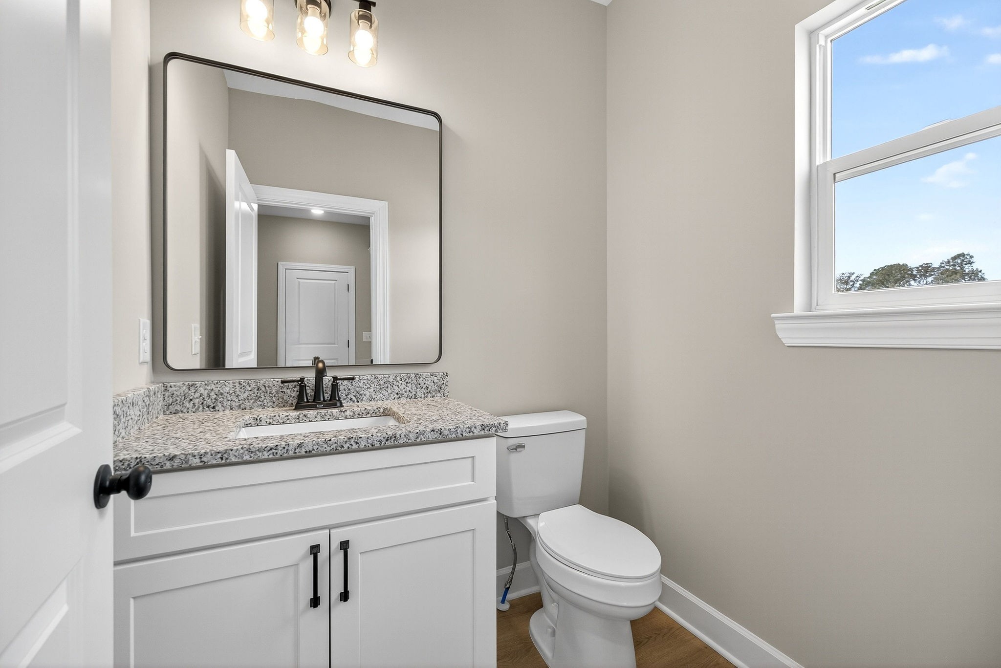 774 C Rody Road McMinnville, TN 37110 - Photo 15 of 40 a bathroom with a granite countertop toilet sink and mirror