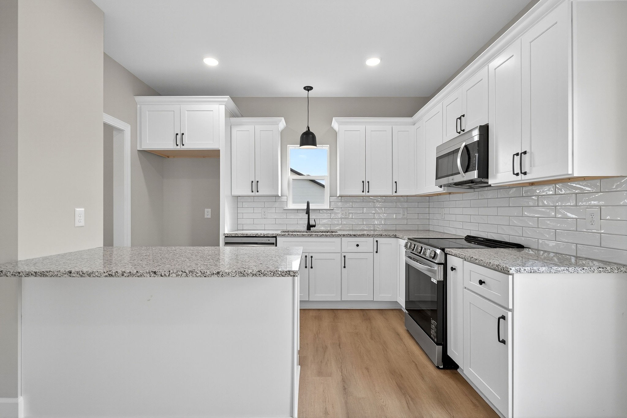 774 C Rody Road McMinnville, TN 37110 - Photo 7 of 40 a kitchen with granite countertop white cabinets and white appliances