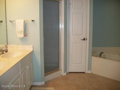 8911 Lake Drive, Unit 206 Cape Canaveral, FL 32920 - Photo 14 of 22 a bathroom with a tub sink and mirror