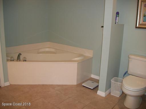 8911 Lake Drive, Unit 206 Cape Canaveral, FL 32920 - Photo 15 of 22 a bathroom with a toilet and a sink