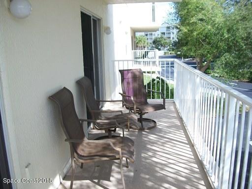 8911 Lake Drive, Unit 206 Cape Canaveral, FL 32920 - Photo 19 of 22 a view of balcony with wooden floor