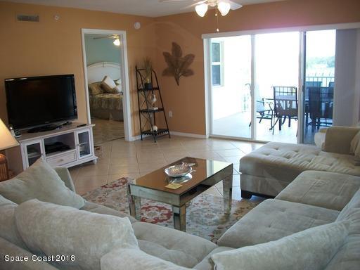 8911 Lake Drive, Unit 206 Cape Canaveral, FL 32920 - Photo 5 of 22 a living room with furniture and a flat screen tv