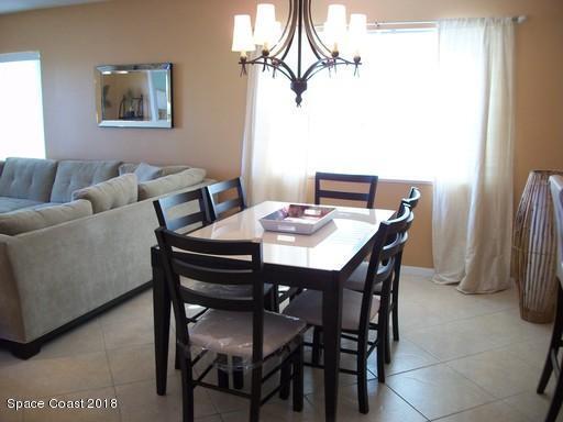 8911 Lake Drive, Unit 206 Cape Canaveral, FL 32920 - Photo 7 of 22 a view of a dining room with furniture
