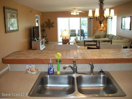 a kitchen view with granite countertop a sink and a counter top space