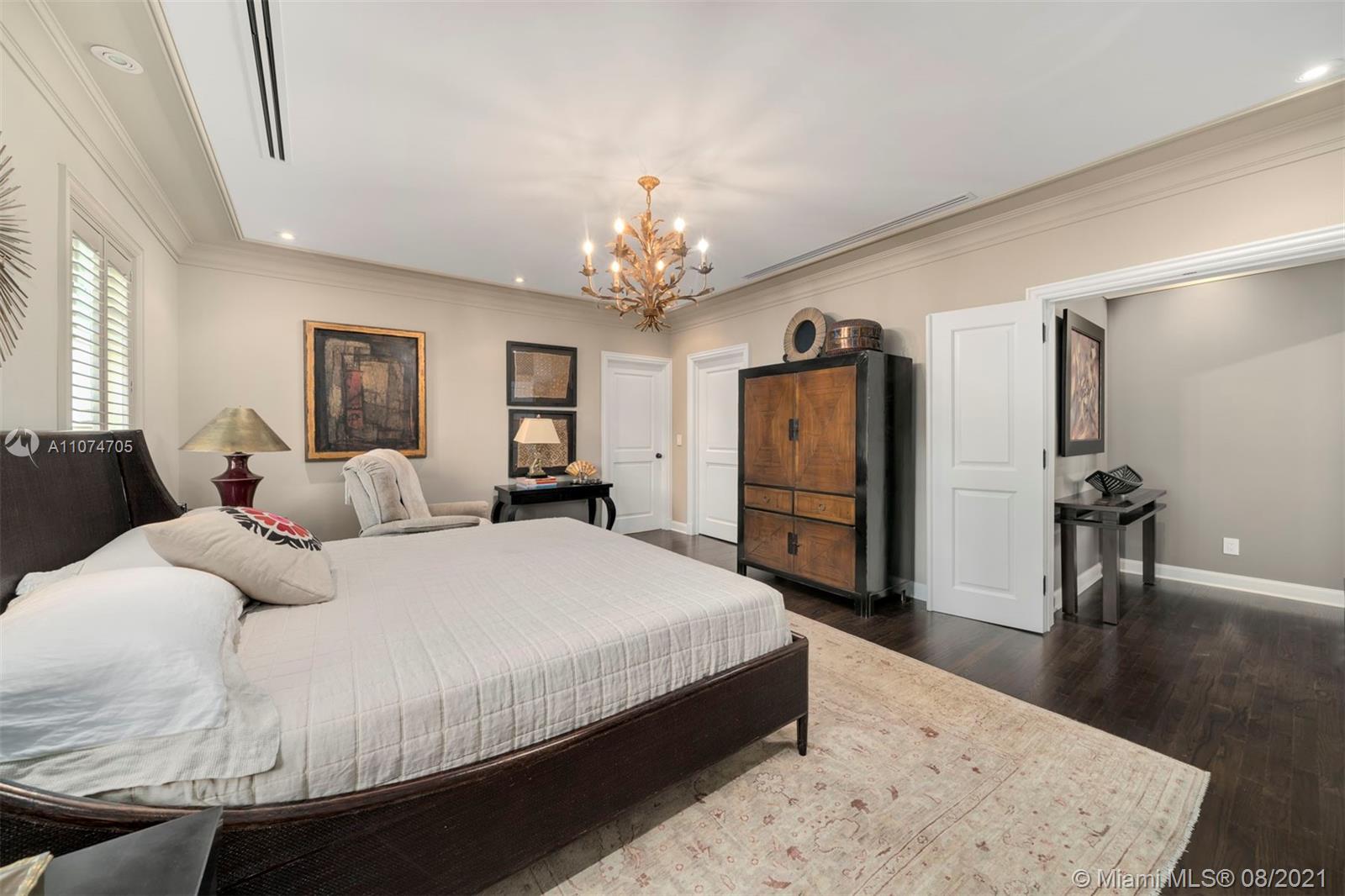 1000 Hardee Road Coral Gables, FL 33146 - Photo 14 of 26 a spacious bedroom with a bed a dresser and mirror