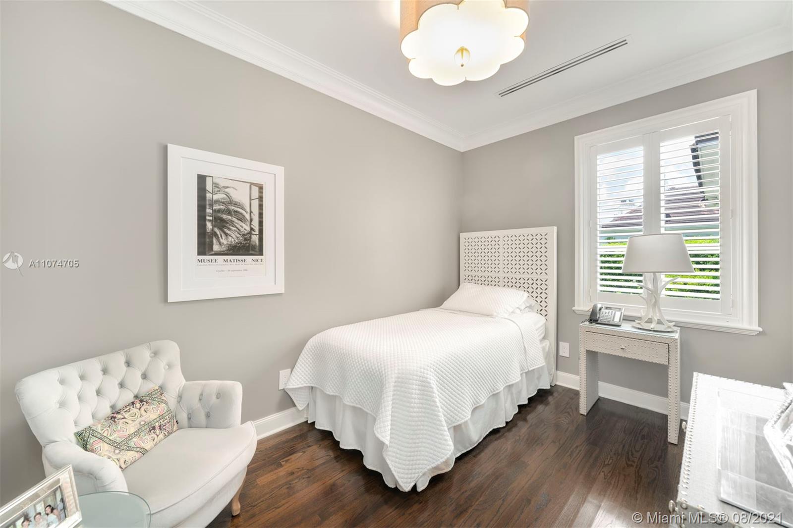 1000 Hardee Road Coral Gables, FL 33146 - Photo 20 of 26 a bedroom with a bed and wooden floor