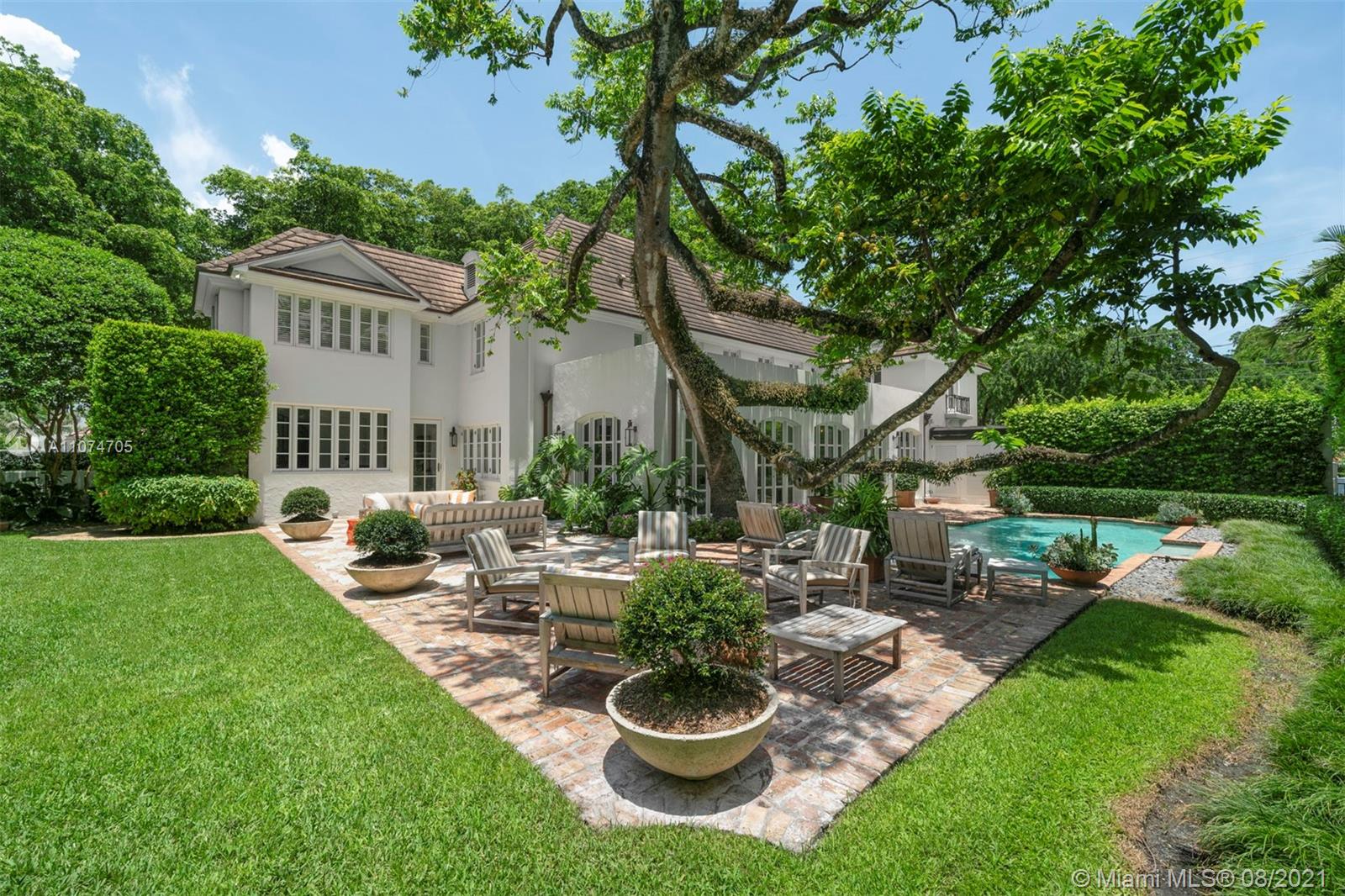 1000 Hardee Road Coral Gables, FL 33146 - Photo 23 of 26 a view of a patio with table and chairs potted plants and a large tree