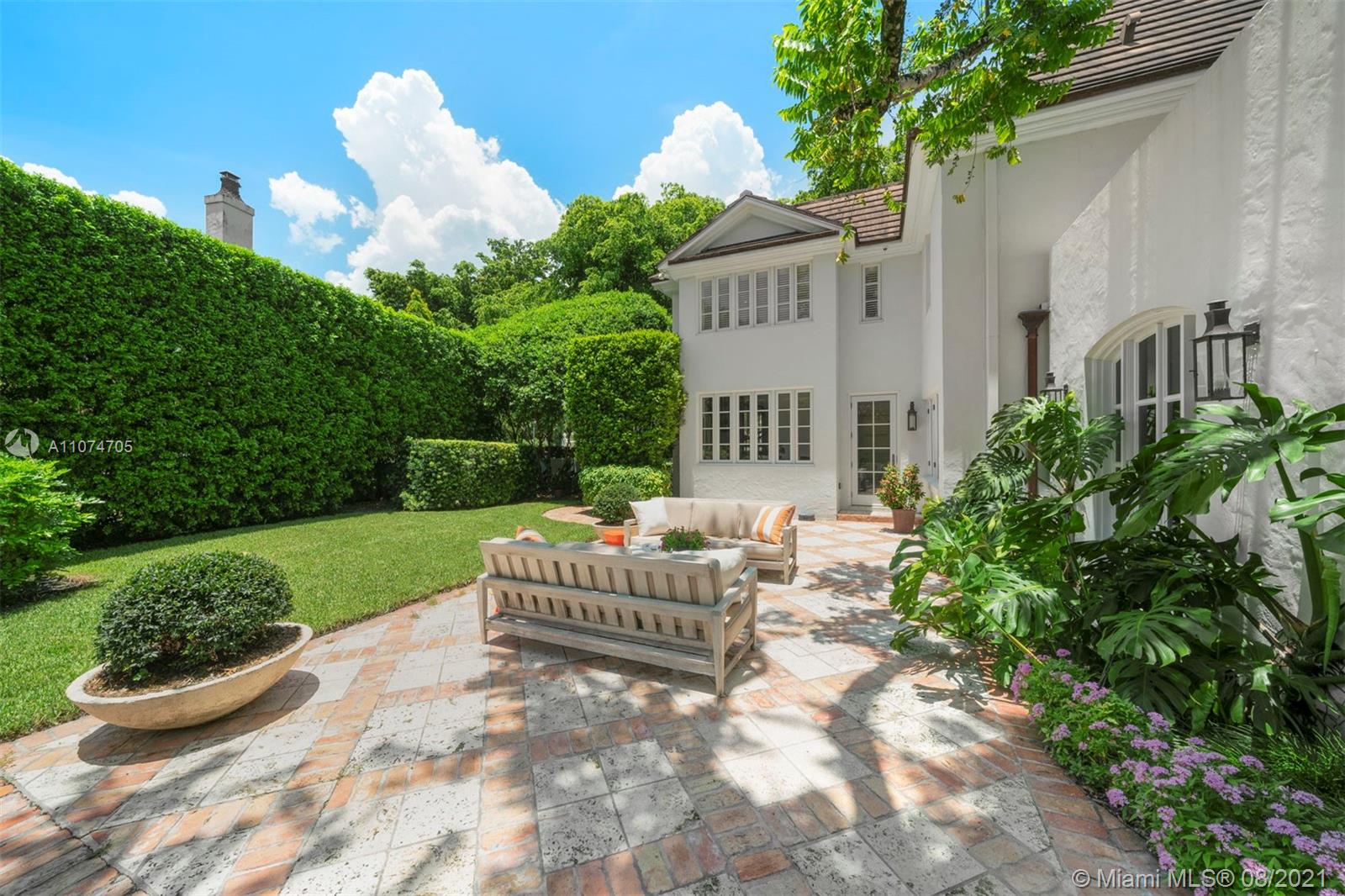 1000 Hardee Road Coral Gables, FL 33146 - Photo 24 of 26 a view of a chair and table in backyard of the house