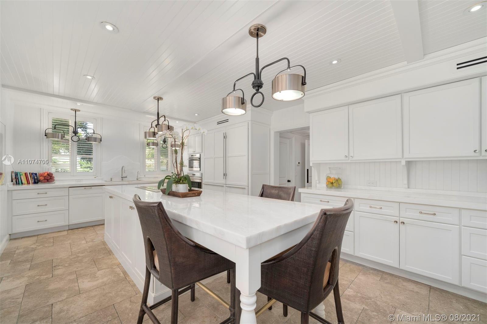 1000 Hardee Road Coral Gables, FL 33146 - Photo 6 of 26 a kitchen with a dining table chairs sink and cabinets