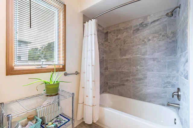 a bathroom with a bathtub and a shower