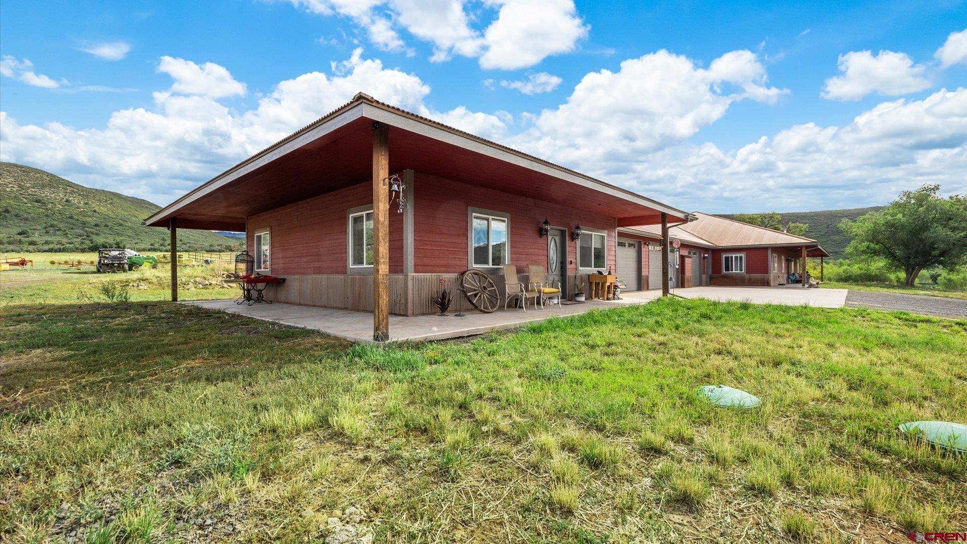 25571 Vail Road Cedaredge, CO 81413 - Photo 27 of 35 a backyard of a house with table and chairs