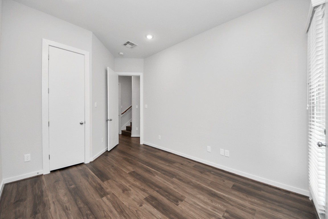 608 Thornton Road, Unit A Houston, TX 77018 - Photo 16 of 44 a view of an empty room with wooden floor and a window