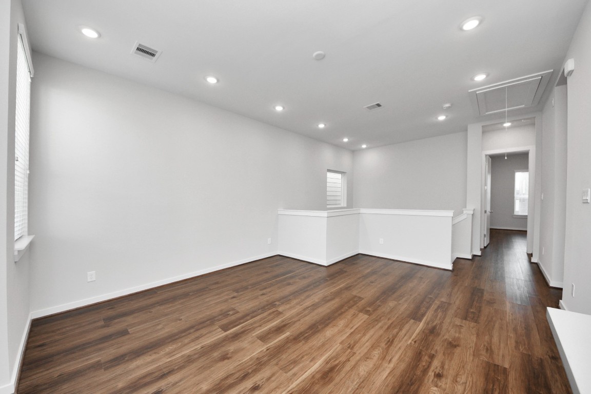 608 Thornton Road, Unit A Houston, TX 77018 - Photo 25 of 44 a view of empty room with wooden floor and windows