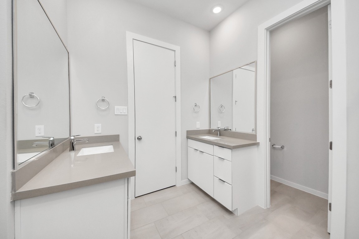 608 Thornton Road, Unit A Houston, TX 77018 - Photo 43 of 44 a bathroom with a granite countertop sink a mirror and a shower