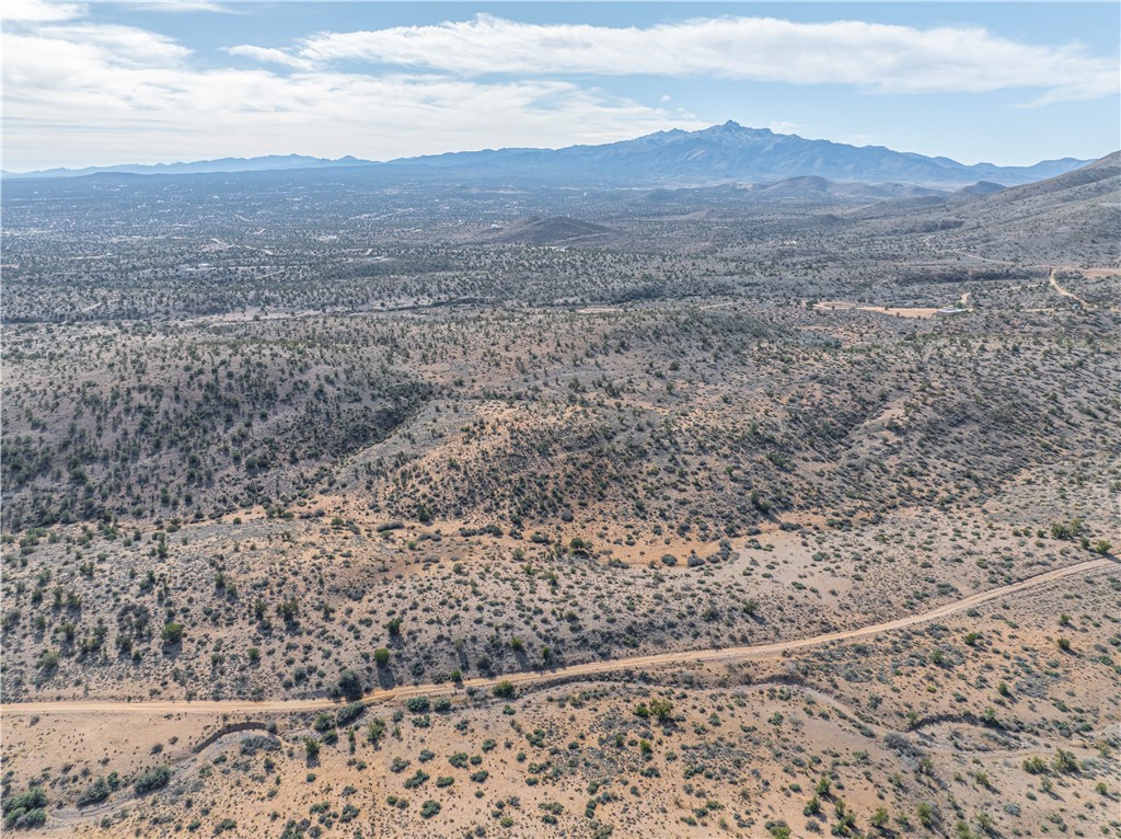10700 Rodeo Drive Kingman, AZ 86401 - Photo 3 of 11 a view of a dry yard with wooden floor and a mountain view