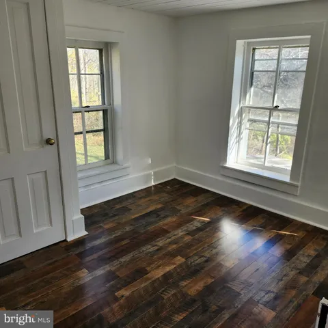 a living room with a bed furniture and a window