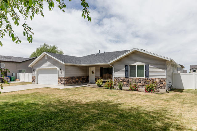 Ranch-style exterior featuring light-colored siding and a stone facade