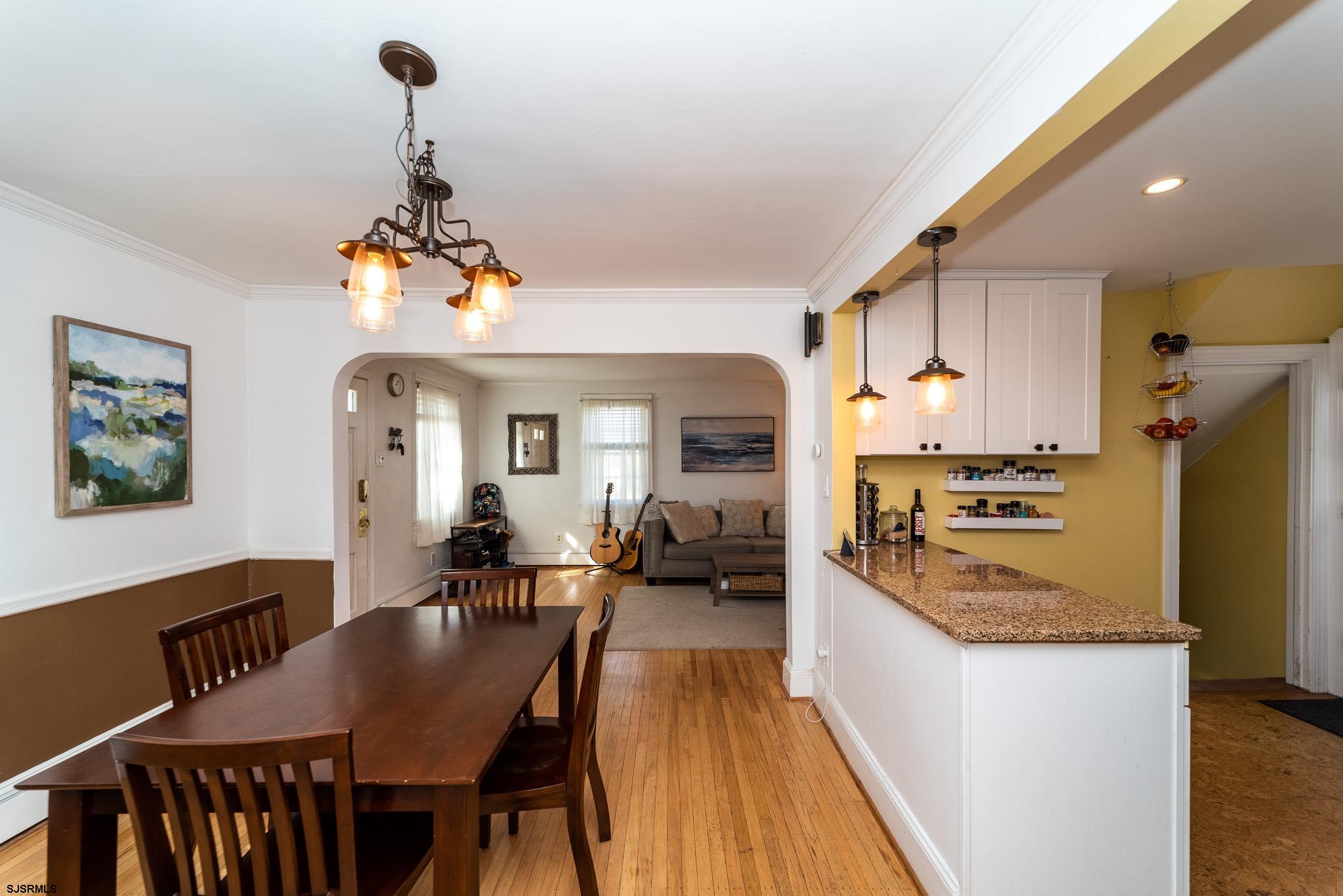 601 Amherst Road Audubon, NJ 08106 - Photo 11 of 30 a view of a dining room and livingroom with furniture wooden floor a chandelier