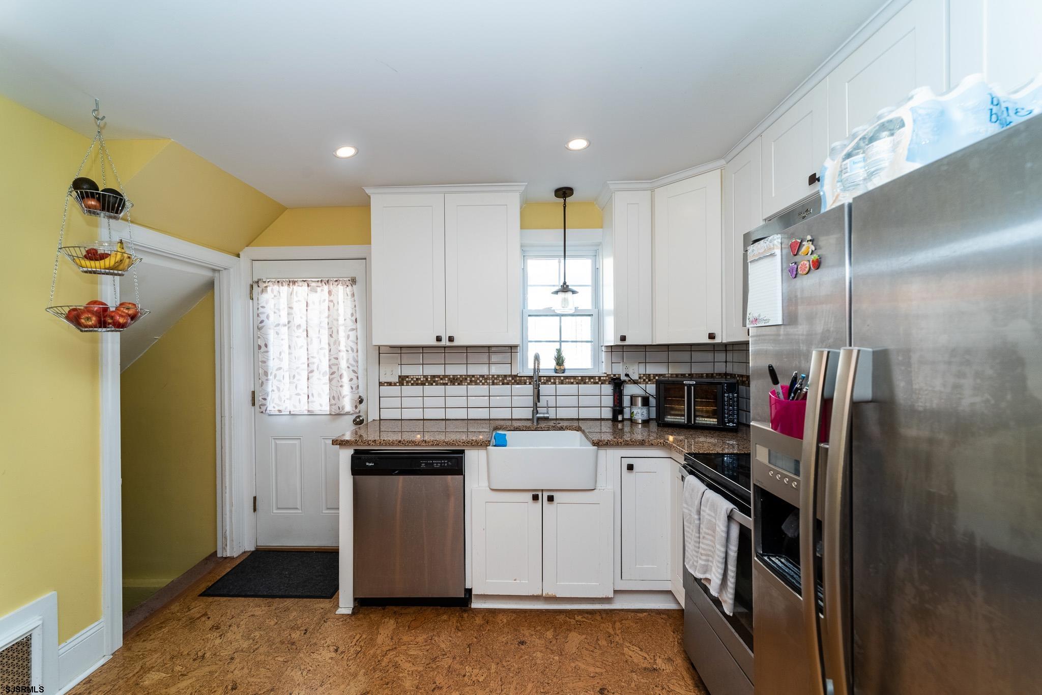 601 Amherst Road Audubon, NJ 08106 - Photo 12 of 30 a kitchen with stainless steel appliances granite countertop a stove a sink and a refrigerator