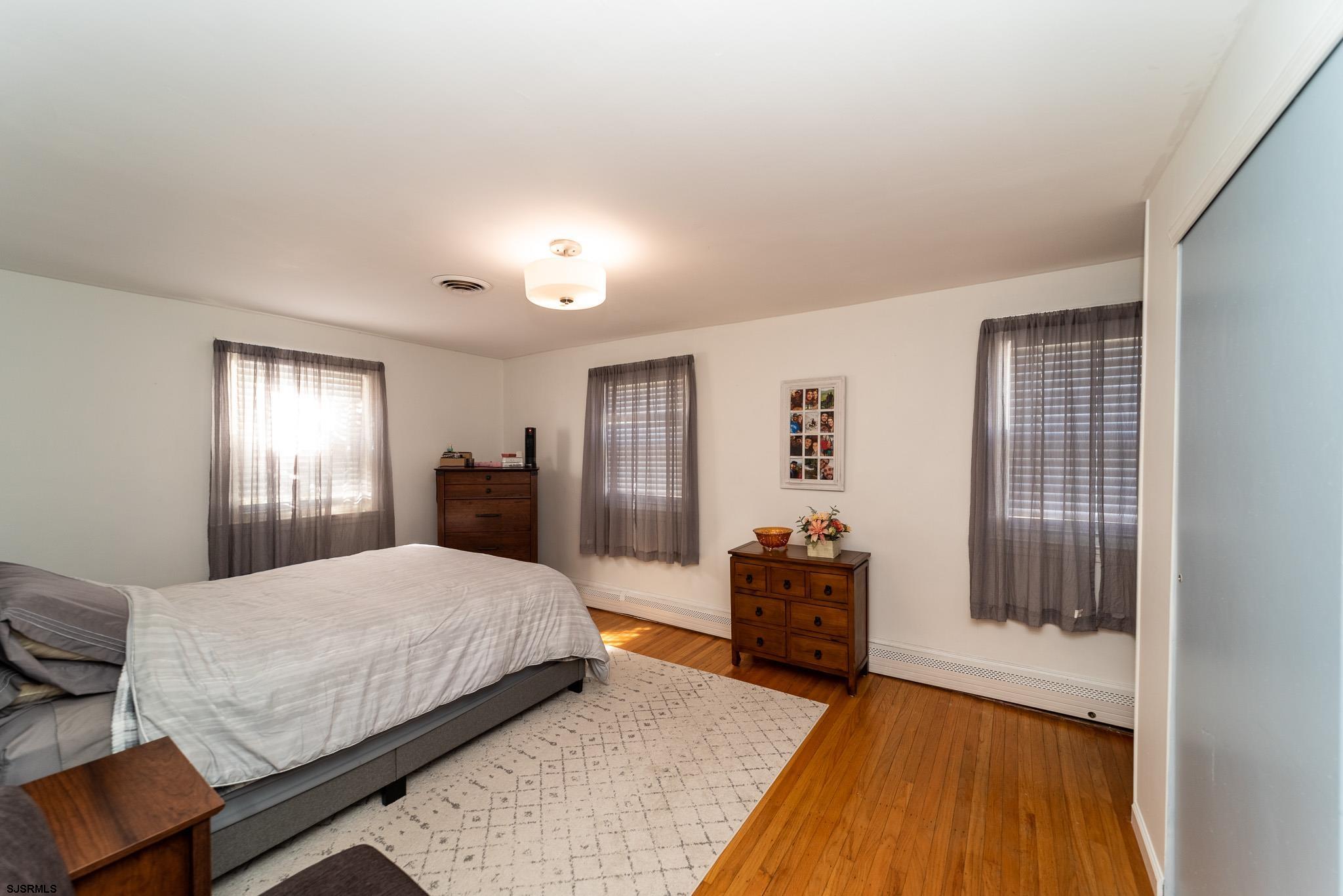 601 Amherst Road Audubon, NJ 08106 - Photo 16 of 30 a bedroom with a bed and a chandelier