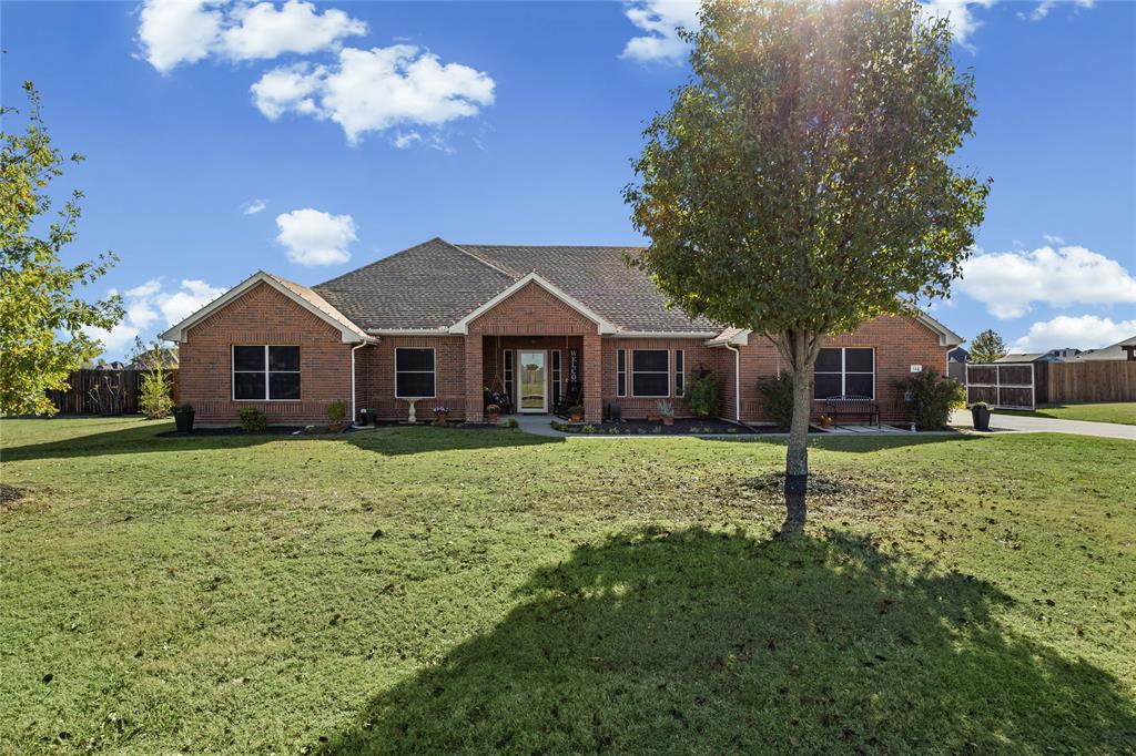 112 Springfield Lane Red Oak, TX 75165 - Photo 3 of 40 a front view of a house with a garden and trees
