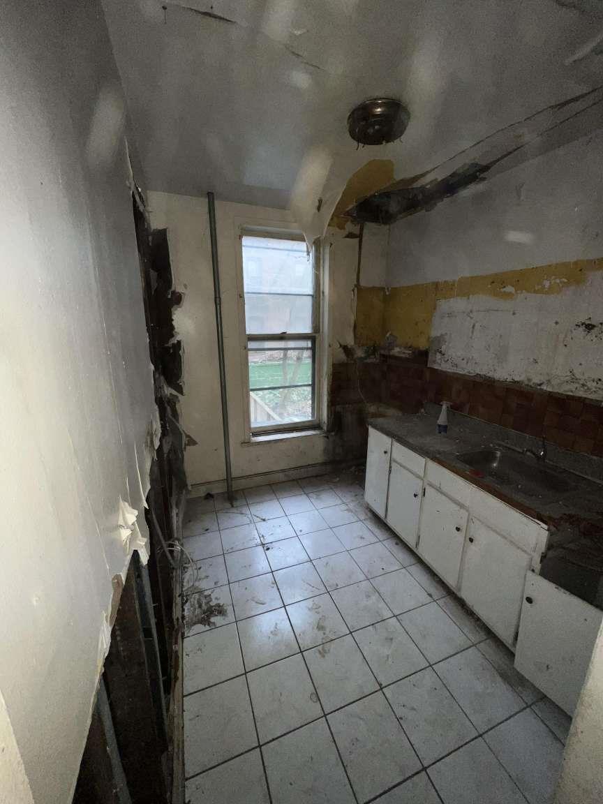 1430 Pacific Street Brooklyn, NY 11216 - Photo 15 of 24 Kitchen featuring white cabinetry and sink
