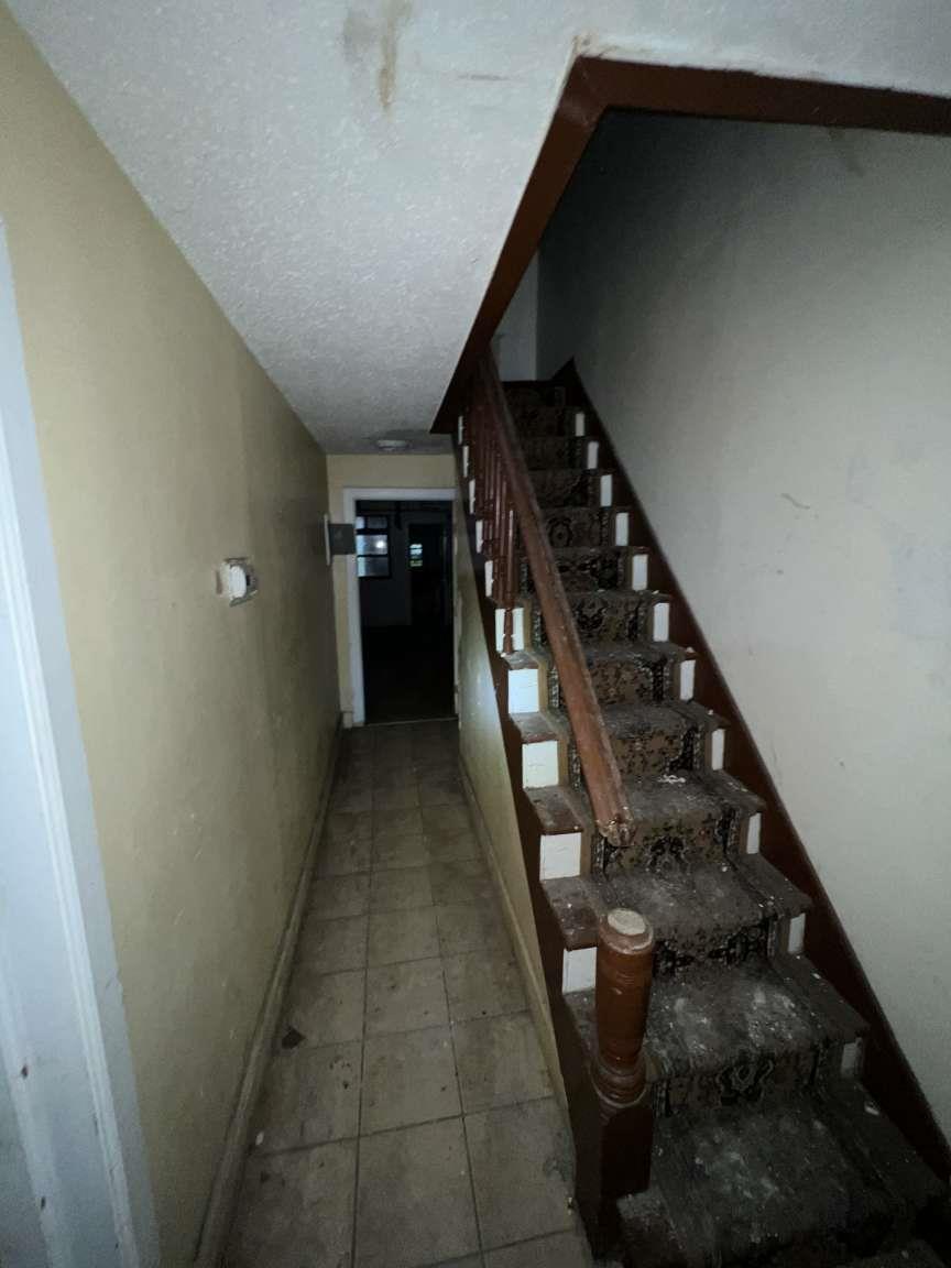 1430 Pacific Street Brooklyn, NY 11216 - Photo 17 of 24 Stairway with tile patterned floors and a textured ceiling