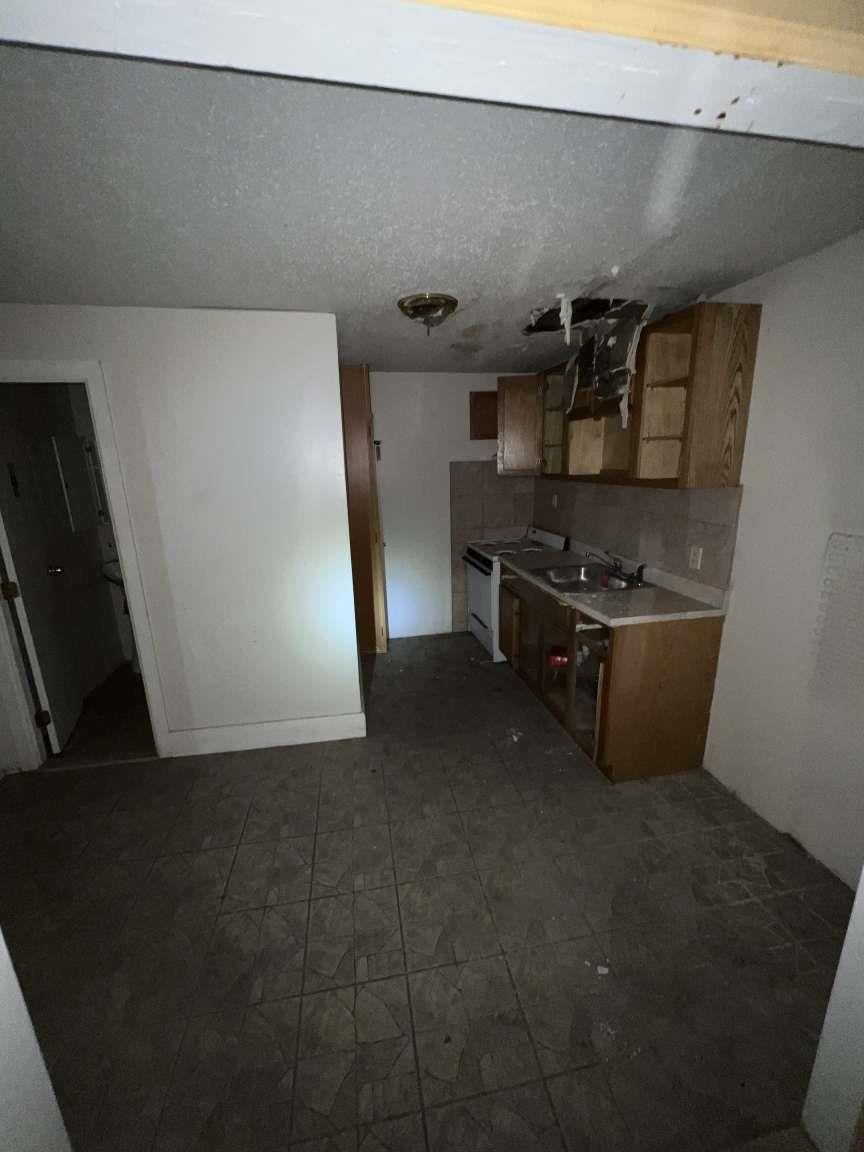 1430 Pacific Street Brooklyn, NY 11216 - Photo 9 of 24 Kitchen with sink, decorative backsplash, and white range with electric stovetop
