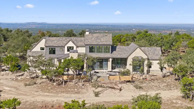 an aerial view of a house with a yard table and chairs