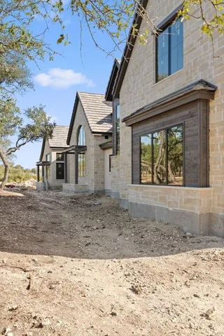 a view of a grey house with a yard