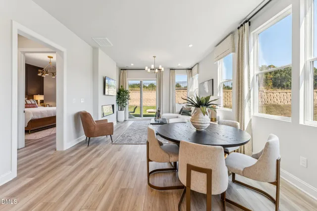 a living room with furniture wooden floor and a chandelier