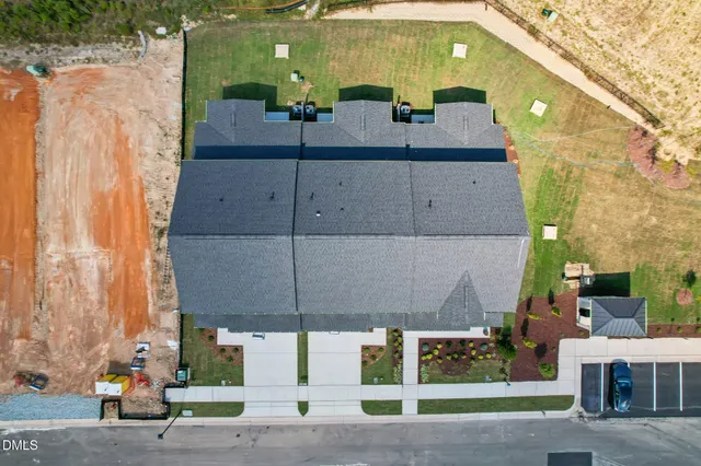 an aerial view of a house with a yard and lake view