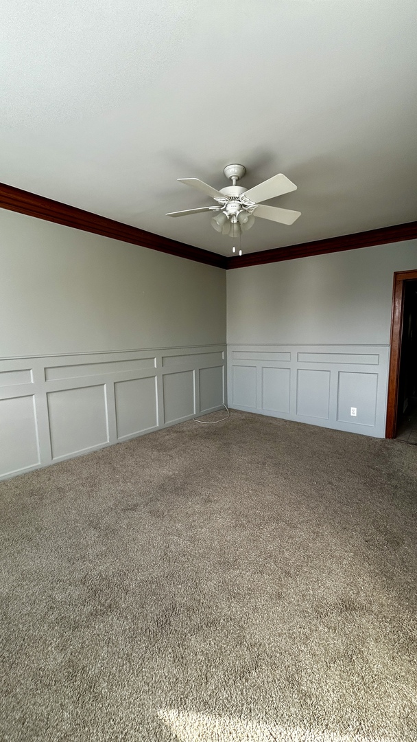 8406 South Brandon Avenue, Unit 2 Chicago, IL 60617 - Photo 2 of 9 a view of a livingroom with an empty space and a ceiling fan