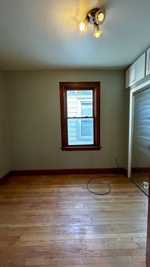 8406 South Brandon Avenue, Unit 2 Chicago, IL 60617 - Photo 7 of 9 an empty room with a window