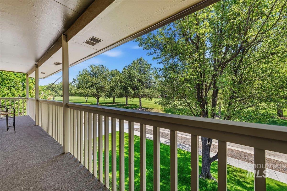 599 Pebble Beach Way Eagle, ID 83616 - Photo 31 of 44 Spacious outdoor balcony with a carpeted surface, supported by painted wooden columns and railing, providing open-air access