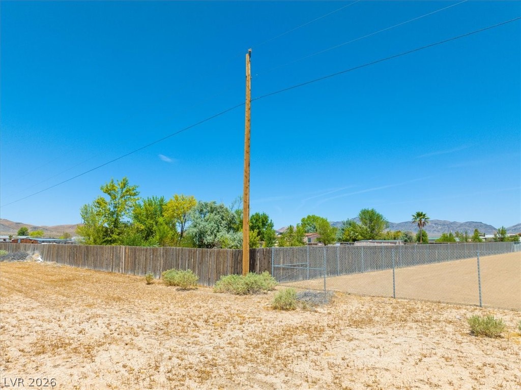 4610 Lawrence Road Pahrump, NV 89048 - Photo 14 of 42 A spacious lot offers boundless opportunities for your desert retreat, framed by a sturdy fence.