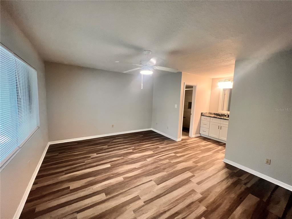 17 Escondido Circle, Unit 239 Altamonte Springs, FL 32701 - Photo 15 of 30 a view of empty room with wooden floor and fan
