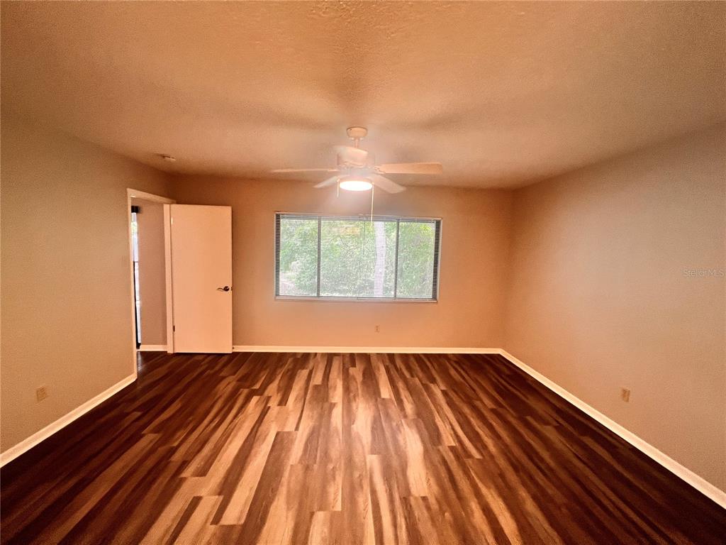 17 Escondido Circle, Unit 239 Altamonte Springs, FL 32701 - Photo 16 of 30 a view of an empty room with wooden floor and a window