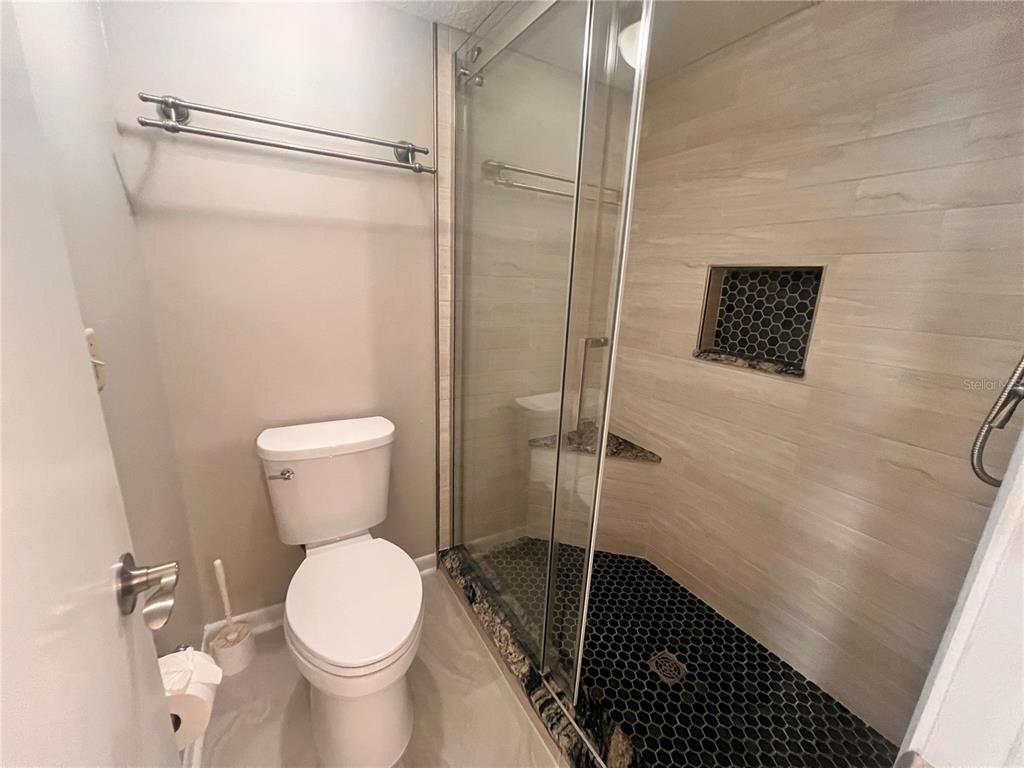 17 Escondido Circle, Unit 239 Altamonte Springs, FL 32701 - Photo 19 of 30 a bathroom with a toilet and a shower