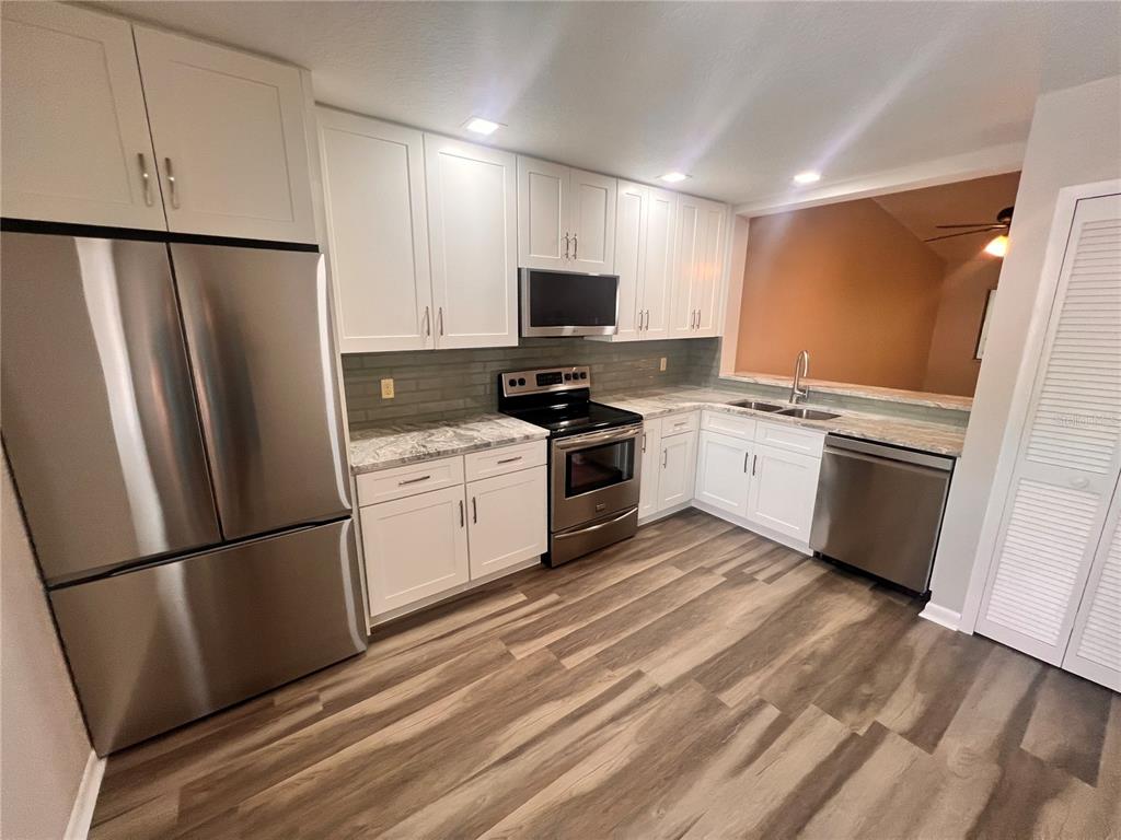 17 Escondido Circle, Unit 239 Altamonte Springs, FL 32701 - Photo 4 of 30 a kitchen with a refrigerator stove and sink