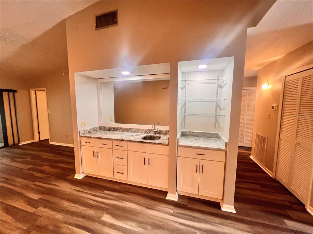 17 Escondido Circle, Unit 239 Altamonte Springs, FL 32701 - Photo 6 of 30 a bathroom with a granite countertop sink and a mirror