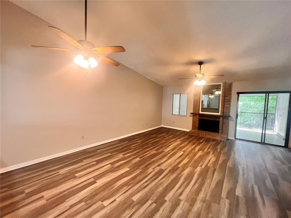 17 Escondido Circle, Unit 239 Altamonte Springs, FL 32701 - Photo 7 of 30 a view of empty room with wooden floor and fan