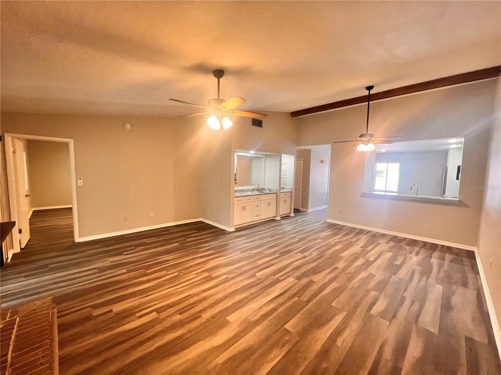 17 Escondido Circle, Unit 239 Altamonte Springs, FL 32701 - Photo 8 of 30 a view of empty room with wooden floor and fan