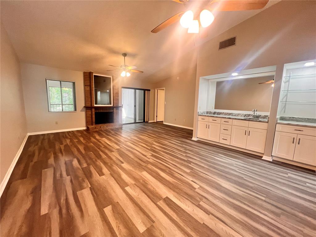 17 Escondido Circle, Unit 239 Altamonte Springs, FL 32701 - Photo 9 of 30 a view of a kitchen with wooden floor and a sink