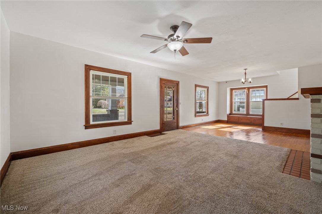 26903 Butternut Ridge Road North Olmsted, OH 44070 - Photo 7 of 37 Unfurnished living room featuring carpet flooring, ceiling fan with notable chandelier, and baseboards