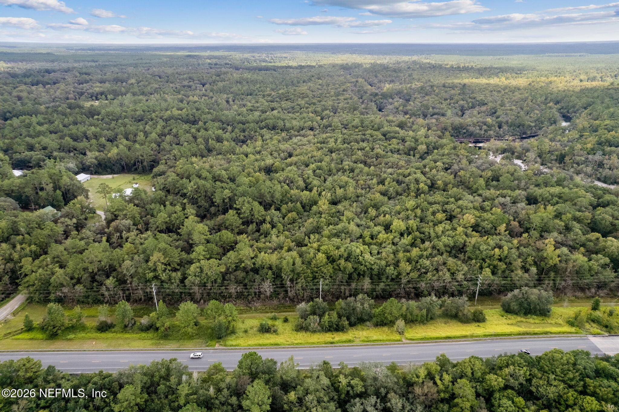 0 Tom Crawford Road Hilliard, FL 32046 - Photo 5 of 5 a view of a swimming pool with an outdoor space and seating area